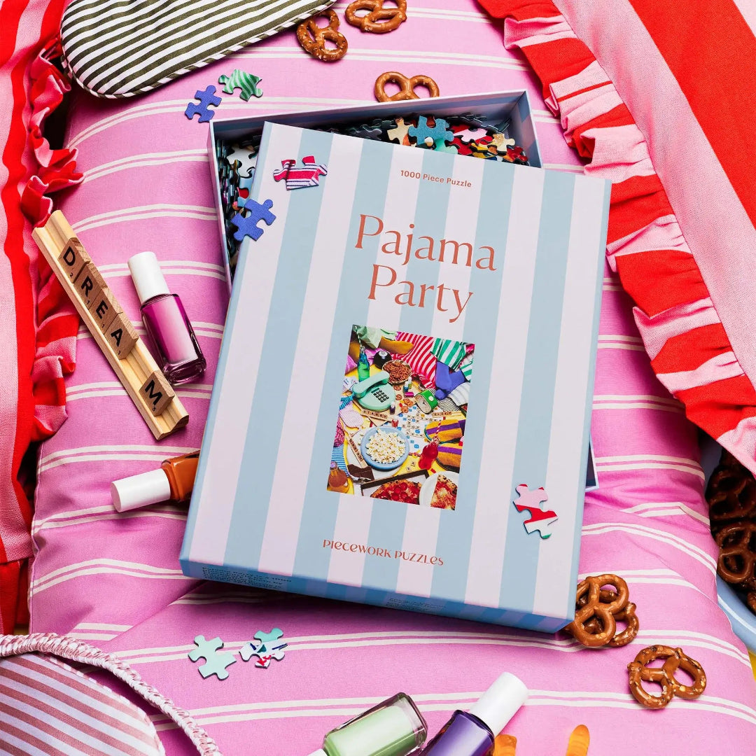Pajama Party puzzle box on a pink striped pillow with decorative items