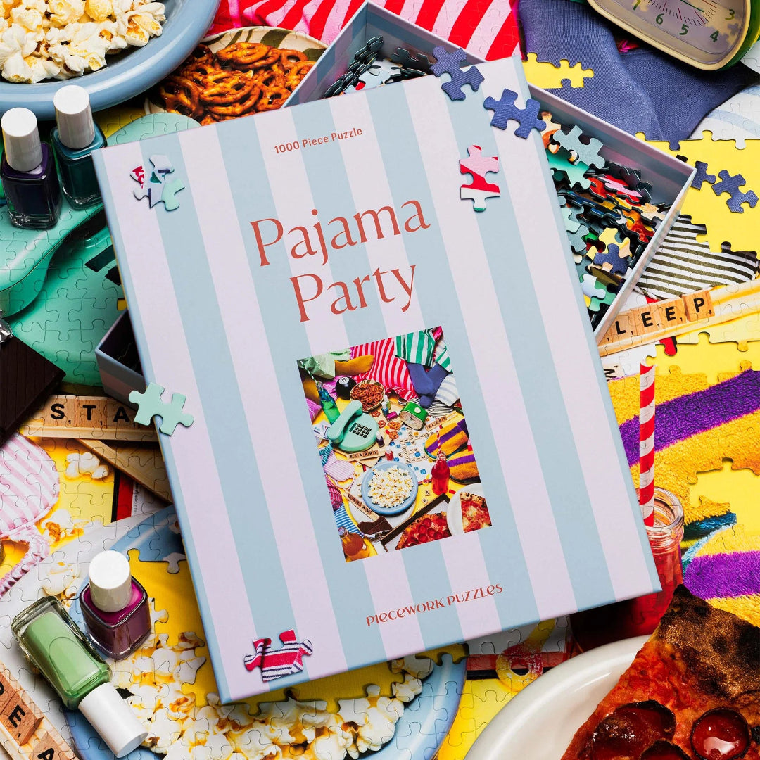 Pajama Party puzzle box with puzzle pieces and snacks on a table